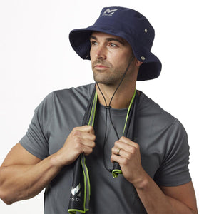 Man wearing a navy Mission bucket hat and a cooling towel around his neck