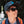 Person wearing Smith sunglasses and a baseball cap with an orange backpack