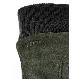 Close up of dark green suede Hestra glove with ribbed cuff