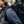 Person wearing a blue FjallRaven fleece with a FjallRaven logo patch and a backpack