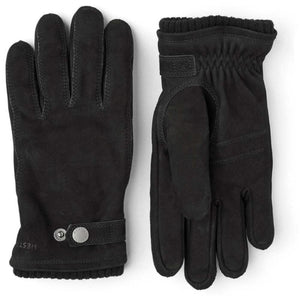 Pair of black Hestra suede gloves with snap button closure and ribbed cuffs