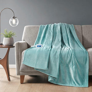 Beautyrest teal electric heated throw blanket draped over a grey sofa