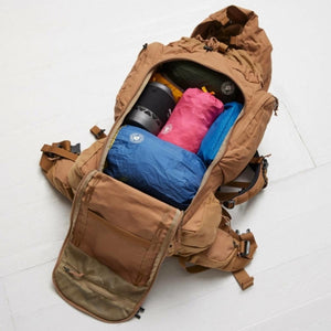 Open Fjallraven backpack packed with colorful gear and camping equipment