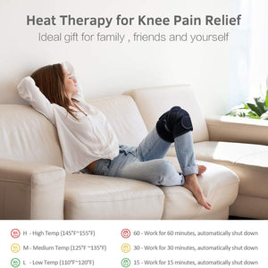 Person wearing a black heated knee brace while relaxing on a sofa with temperature and timer settings displayed