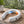 White wearable neck fan with three speed settings and hot or cold temperature modes
