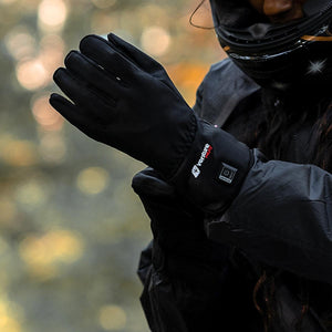 Person wearing black Venture Heat motorcycle gloves with power button on wrist