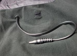 Black power cable with a barrel connector extending from a fabric garment