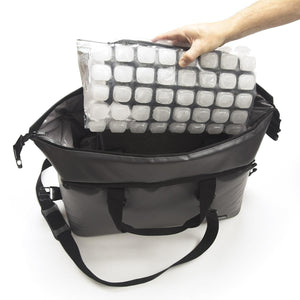 Hand placing a flexible ice pack sheet into an open black insulated cooler bag