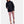 Under Armour black hooded rain jacket worn with mauve leggings and athletic shoes