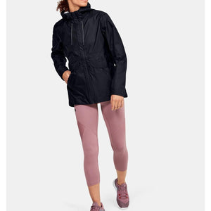 Under Armour black hooded rain jacket worn with mauve leggings and athletic shoes
