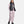 Woman wearing Under Armour black puffer vest over light pink long sleeve top and matching cargo joggers