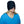 Person wearing a black migraine relief ice cap covering the eyes and head
