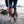 Person wearing brown Xtratuf rubber boots standing in shallow water