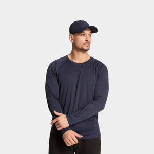 Man wearing a navy Mission long sleeve crew neck shirt and a matching baseball cap