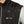 Water beading on the surface of a black Venture Heat vest