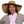 Woman wearing a wide brim straw hat and a pink neck cooling scarf