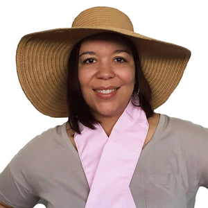 Woman wearing a wide brim straw hat and a pink neck cooling scarf