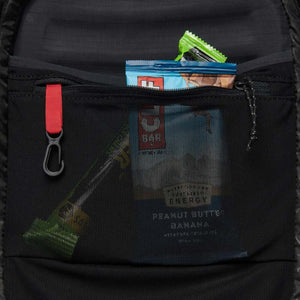 Black Diamond backpack interior mesh pocket containing energy bars and a key clip