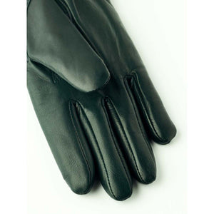 Dark green leather glove on white background