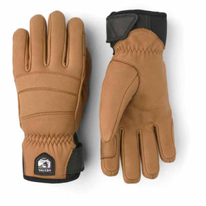 Hestra tan leather gloves with black cuffs and Hestra logo patch