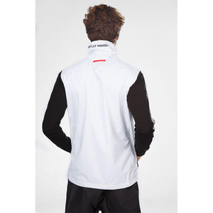 Back view of a person wearing a white Helly Hansen vest over a black long sleeve shirt