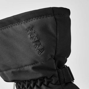 Close up of black Hestra glove cuff with embroidered logo