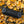 Outdoor Tech portable speaker resting on yellow autumn leaves