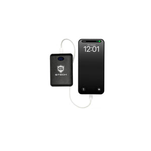 G-Tech power bank connected to a smartphone by a white charging cable