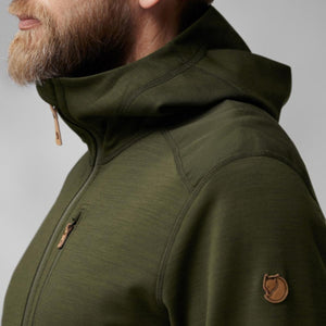 Side profile of a man wearing a green FjallRaven hooded fleece jacket with leather zipper pulls