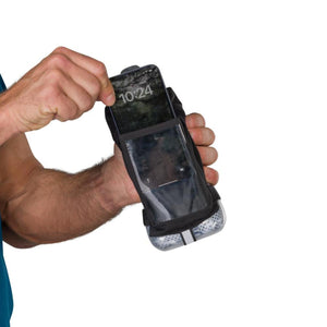 Hand inserting a smartphone into a black running hand strap