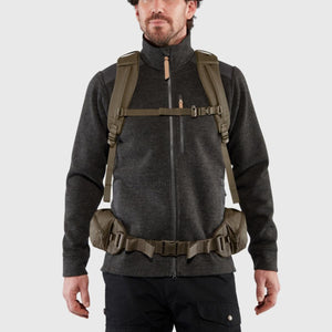 Man wearing a FjallRaven backpack with a waist belt and shoulder straps