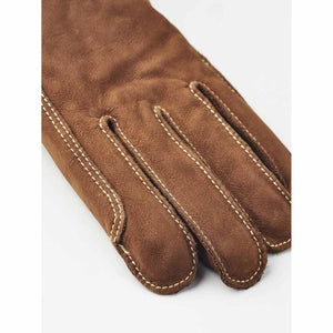 Hestra brown leather glove with visible white stitching