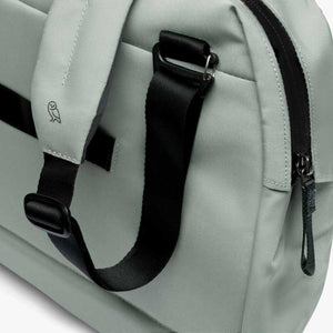Close up of sage green Bellroy bag strap and zipper detail