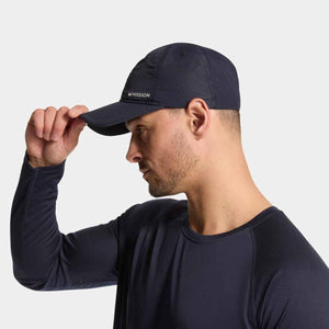 Man wearing a navy Mission baseball cap