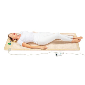Person lying on a HealthyLine infrared heating mat with a digital controller