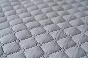 Close up of grey Shield Life quilted fabric texture