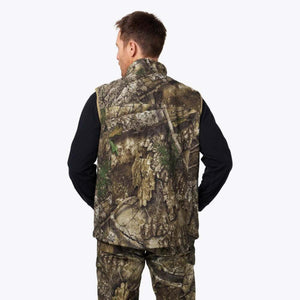 Back view of a man wearing a Mobile Warming camouflage vest over a black long sleeve shirt