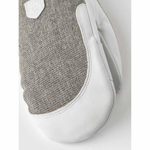 Hestra grey textured fabric mitten with white leather palm and logo patch