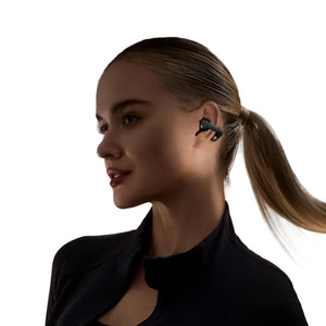 Woman wearing black open ear wireless headphones