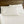 White bed sheets and pillowcases on a bed with a dark wood headboard