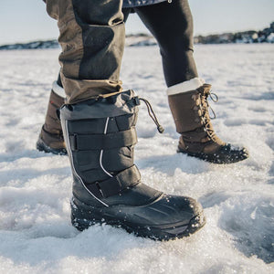 Two people wearing Baffin winter boots walking on snow