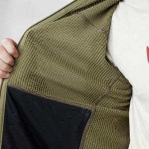 Close up of olive green waffle knit fleece lining inside a zippered jacket