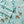 Shavel fabric with winter forest pattern featuring deer and cabins on light green background